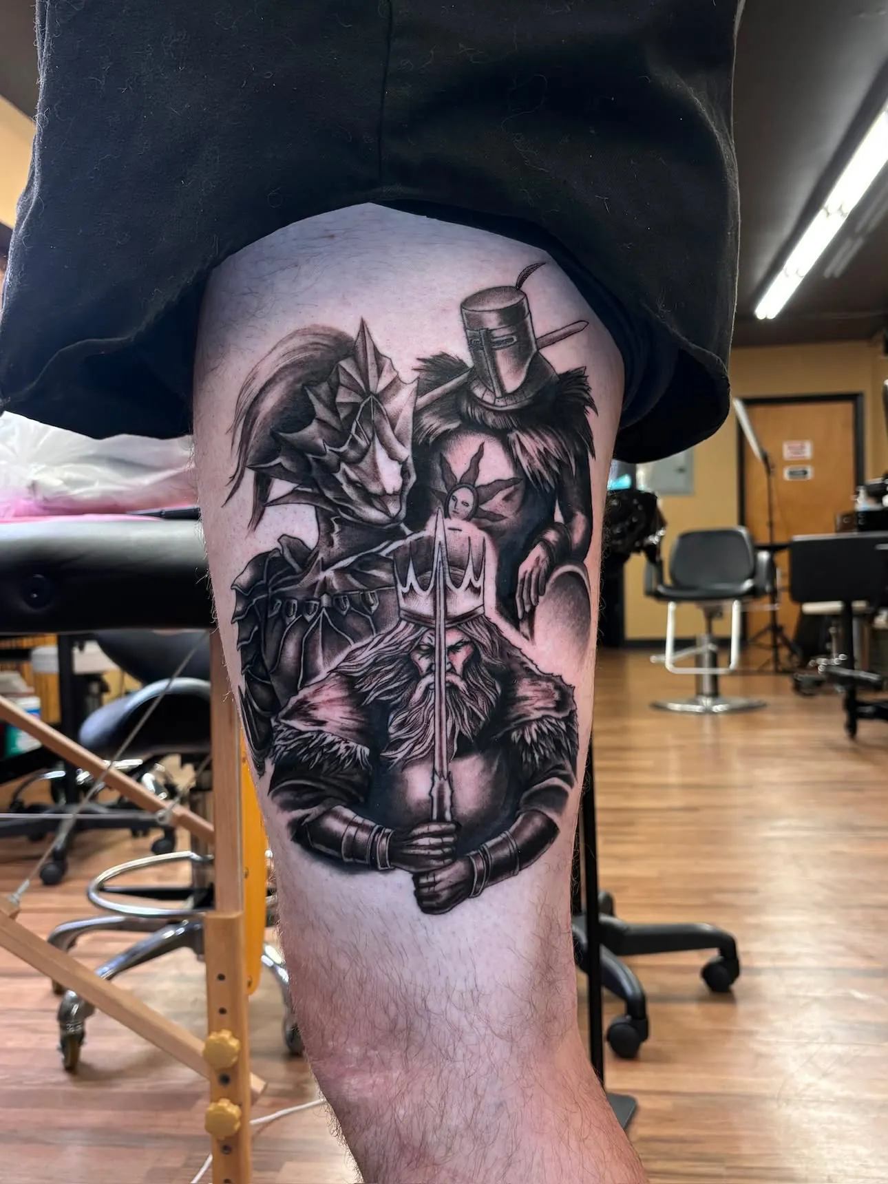 Large-scale berserker knight anime thigh tattoo