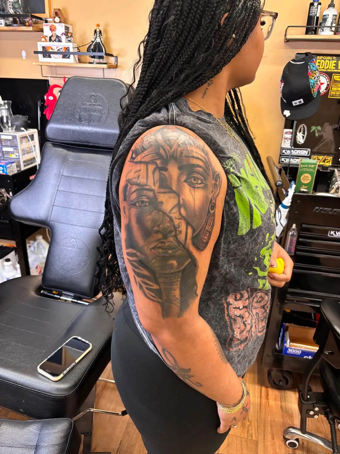 Black and grey Egyptian portrait sleeve tattoo on melanated skin